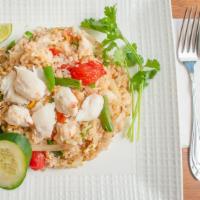 Crab Meat Fried Rice · Jumbo lumps of crab meat sautéed with egg, onions, scallions, tomatoes, and mixed vegetables.