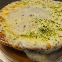 French Onion Soup · Homemade french onion soup topped with crispy crutons and melted provolone cheese