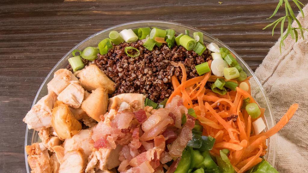 The Green Bay Salad · chopped romaine, quinoa, shredded carrot, scallions, green peppers, cheddar cheese, roasted chicken, roasted bacon, sesame seeds, lemon vinaigrette dressing