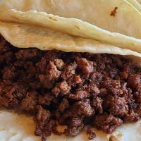 Tacos De Chorizo · Three soft corn or flour tortilla tacos with chorizo “Mexican sausage”. Served with beans, P...