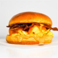 Brioche, Bacon, Egg, & Cheddar Sandwich · 2 scrambled eggs, melted Cheddar cheese, smoked bacon, and Sriracha aioli on a warm brioche ...