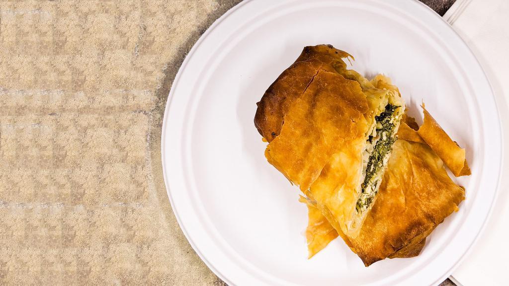 Spinach Pie - Spanakopita · Seasoned spinach and feta cheese layered in a flaky phylo dough and baked to a golden crisp.