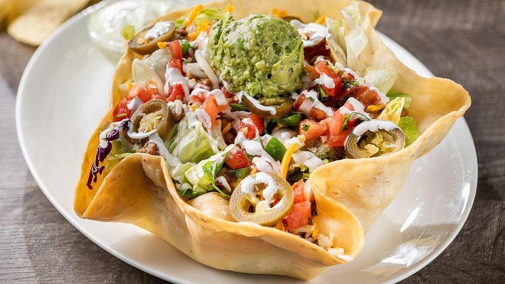 Grande Taco Salad · Seasoned ground beef or chicken tinga on a crisp blend of lettuce & shredded cabbage, mixed cheese, fresh guacamole, lime crema, pico de gallo and pickled jalapeños. Served in a crispy tortilla shell.