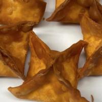 Crab Rangoon · Soft wonton skin stuffed with crab meat, carrot, onion and cream cheese served with sweet an...