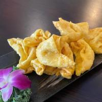 Cheese Wonton · Delicate natural crabmeat mixed with cream cheese, minced onions, and wrapped in a crispy eg...