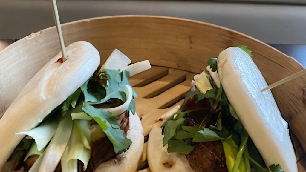 Pork Belly Bun (2) · Two pieces. Steamed bun filled with roasted pork belly, scallion, jalapeño, cilantro and chef's sauce.