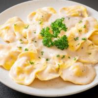 Cheese Ravioli · Fresh ravioli filled with creamy cheese and served with a side salad and garlic bread.