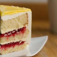 Slice Of Lemon Raspberry Cake · lemon cake filled with lemon curd, crushed raspberries, buttercream