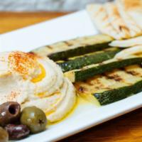 Hummus Plate · Housemade hummus, mixed Mediterranean olives, grilled zucchini, and grilled naan flatbread.