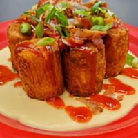Some Like It Tot · Golden fried cheddar stuffed jumbo tots with VT cheddar cheese sauce, caramelized onions, cr...