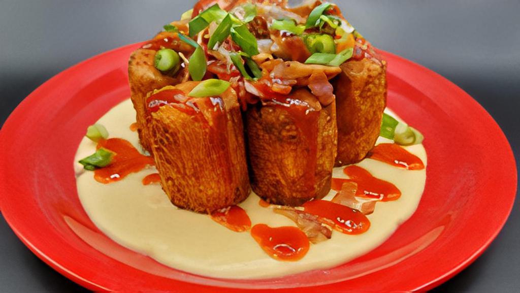 Some Like It Tot · Golden fried cheddar stuffed jumbo tots with VT cheddar cheese sauce, caramelized onions, crumbled bacon, sriracha glaze & scallions.