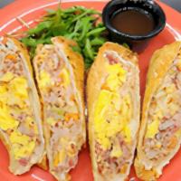 Egg Rolls · Two crispy egg rolls filled with scrambled eggs, house corned beef hash, pickled onion slaw ...