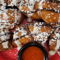 Churro Bites · Crispy fried doughnut pieces tossed in cinnamon & sugar, topped with a creamy cheesecake gla...