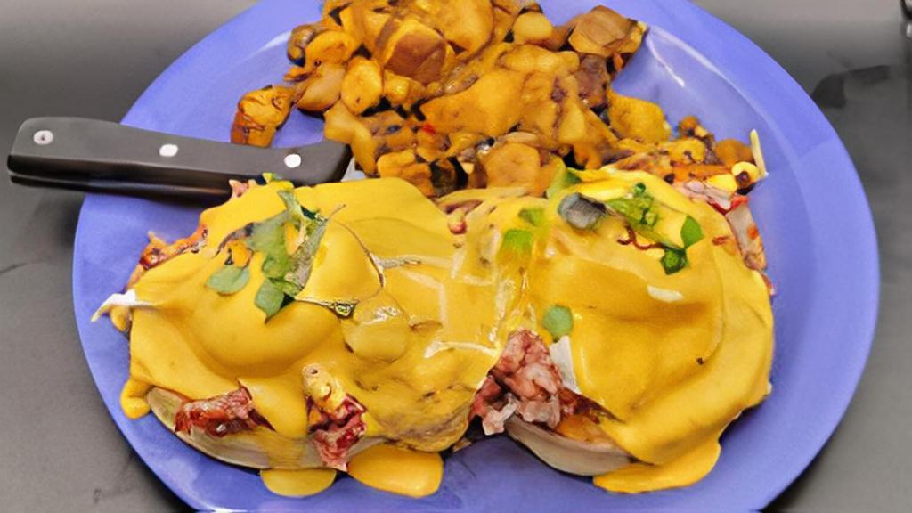 Irish Benny · Thick cut English muffin with our house corned beef hash, two poached eggs & Hollandaise. Served with home fries.