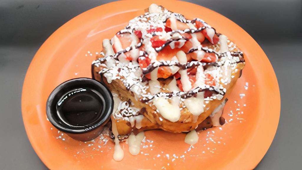 Highway Strawberry · Two slices of thick cut French toast topped with Cheesecake glaze, chocolate drizzle, strawberries & powdered sugar.