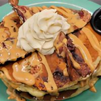 King Cakes · Three mini banana & chocolate chip pancakes – topped with bacon & finished with a peanut but...