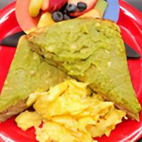 Tiny Avocado Toast · Our toasted wheat bread loaded with avocado. Served with scrambled egg and fruit salad.