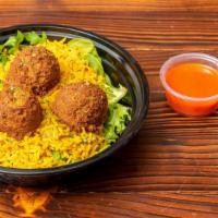New York Style Falafel Over Rice · Three homemade falafel balls served over rice and lettuce. Comes with red and white sauce.