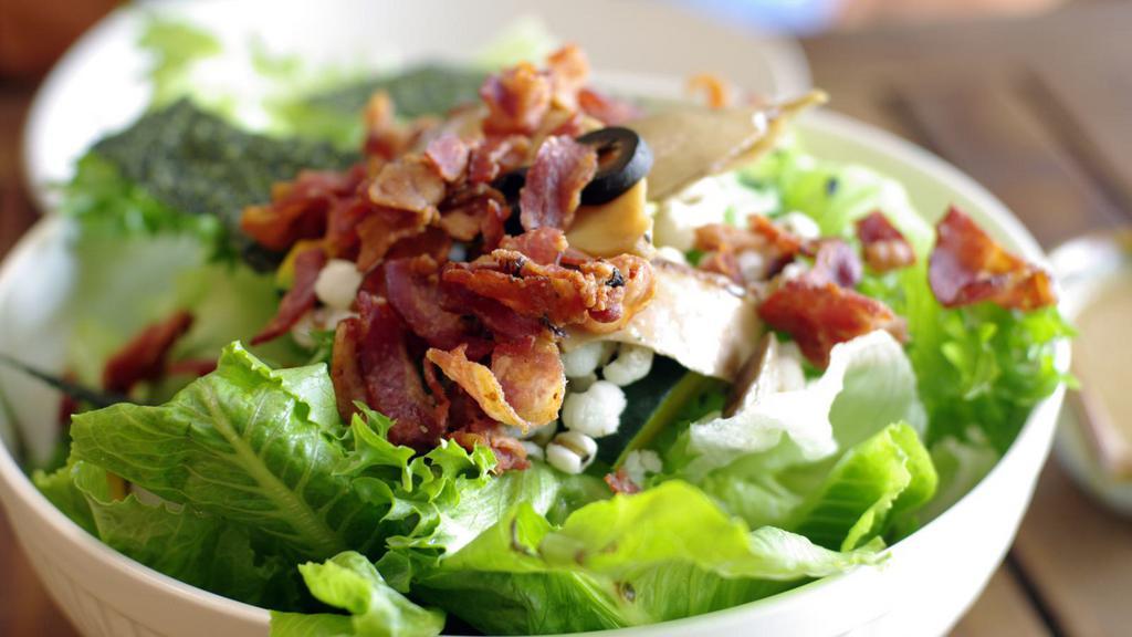 Bacon Salad · Crisp lettuce salad with mouthwatering bacon, black olives, croutons, cucumbers, green peppers, mushrooms, onions, sweet peppers and juicy tomatoes.