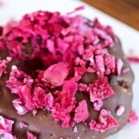 Raw Chocolate Donut · Dates, almond and cashew with rich chocolate glaze and raw cacao powder and topped with coco...