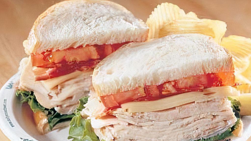Turkey Club · Sliced Turkey Breast served on sourdough bread w/ asiago ranch dressing, lettuce, tomato, swiss, bacon, chips and a pickle.