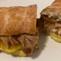 El Cubano · Roasted Pork and Virginia baked ham with Swiss, mayo, mustard, pickles and Cholula hot sauce...