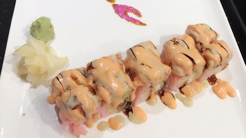 Lobster Rock Roll · Shrimp tempura,eel avocado inside wrapped with pink soy paper top with lobster salad&chef's special sauce.