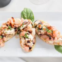 Bruschetta · Lightly toasted bread topped with chopped tomatoes, red onions, basil with evod and balsamic...