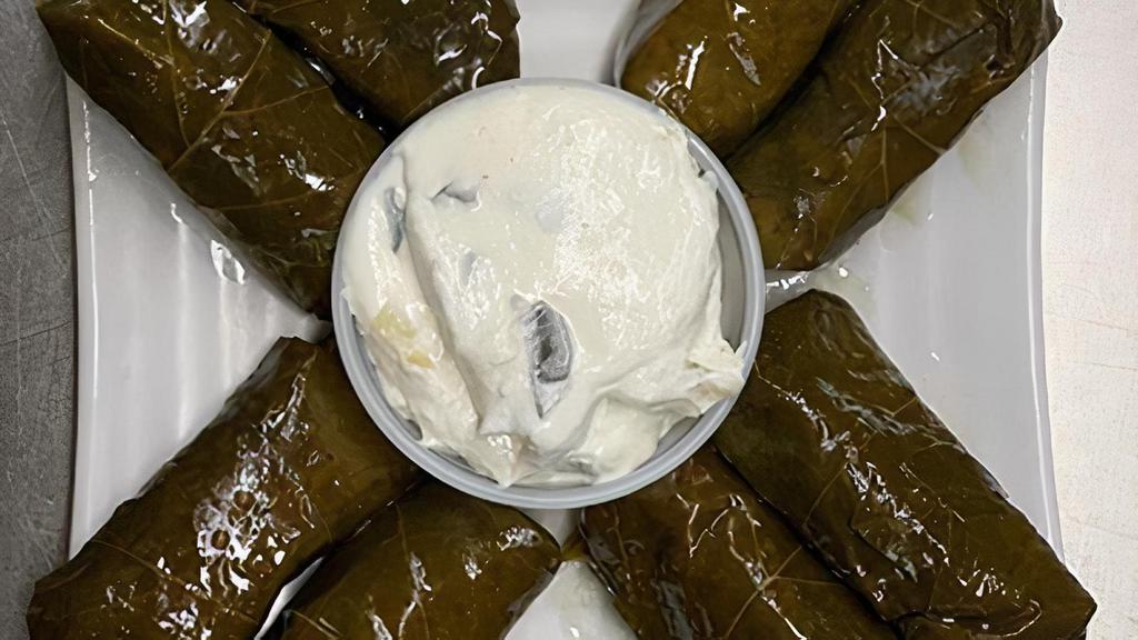 Dolma · Vegetarian Item. Eight peice set. Grape leaves stuffed with rice, onion and parsley. Served with tzatziki.