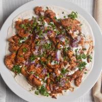 Chicken Shawerma Fatteh · Pita chips, white rice, tahini yogurt sauce, chicken shawerma garnished with parsley and dic...