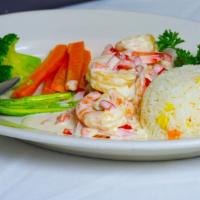 Salmon A La Crema · Grilled Salmon with heavy cream and three shrimps on top, served with sautéed mixed vegetabl...