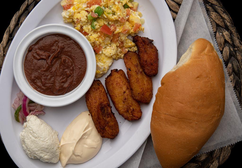 Plato Típico  · Classic Salvadoran breakfast dish. Includes two eggs, refried beans, plantains, Salvadoran style fresh cheese, cream, and bread.