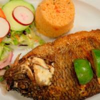 Pescado Frito  · Deep fried whole-seasoned tilapia fish,  Served with rice, salad, and two handmade tortillas.