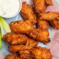 Breaded Buffalo Wings · Cooked wings of a chicken coated in buffalo sauce.