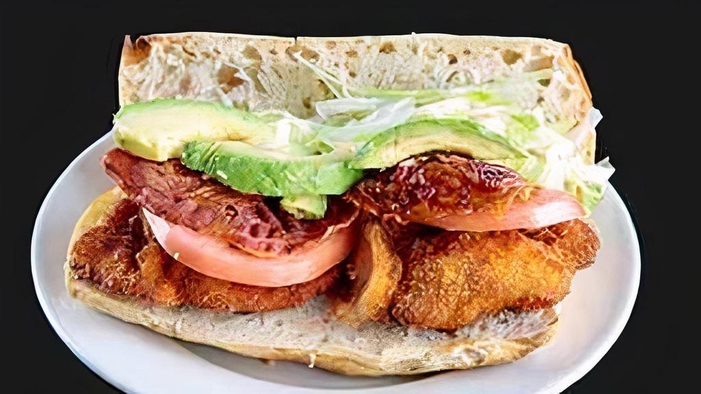 Chicken Avocado Club Sandwich · With lettuce, tomato and bacon.