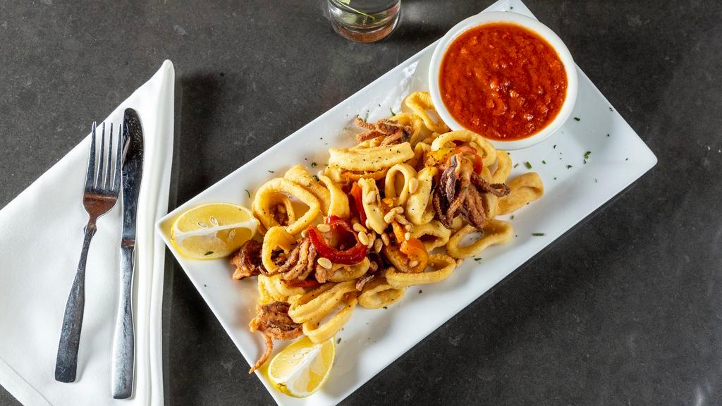 Fried Calamari · With hot cheery peppers & toasted pine nuts. Served with a lemon wedge and a side of marinara sauce.