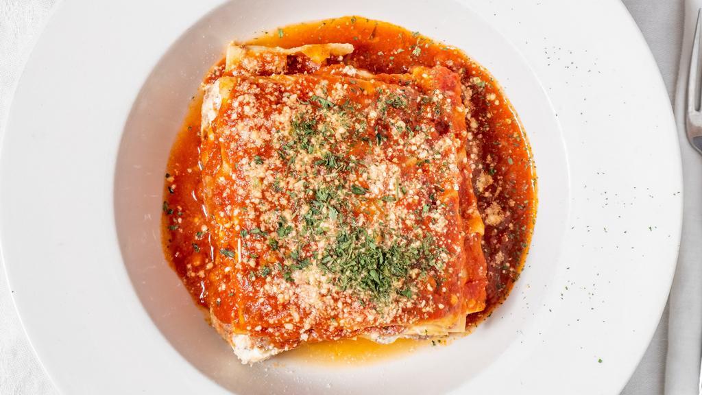 Lasagna · Layers of meat sauce, lasagna noodles and seasoned ricotta cheese. Served with soup of the day & salad.