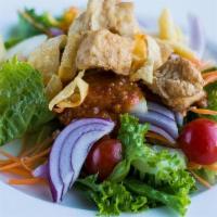 Green Salad · Fresh greens, vegetables, crispy wontons & fried tofu with a light peanut dressing
