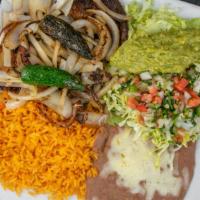 Carne Asada · Thin sliced rib-eye steak topped with fresh jalapeños, avocado, grilled onions and served wi...