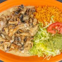 Pollo A La Crema · Grilled chicken breast strips cooked with special cream sauce and mushrooms. Served with ric...
