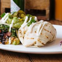 Gringo Burrito · Flour tortilla, rice, cheese, tomato, and lettuce. Topped with crema, guacamole, and jalapeñ...