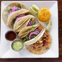 Tacos Al Pastor · Three corn tortillas with grilled pork marinated in pineapple adobo, pineapple, onions, topp...