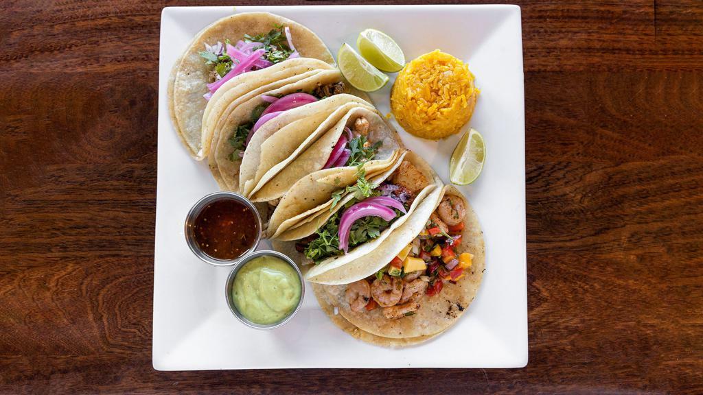 Tacos Al Pastor · Three corn tortillas with grilled pork marinated in pineapple adobo, pineapple, onions, topped with cilantro, served with rice & beans.
