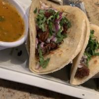 Carnitas Tacos · Three tacos with pork carnitas, onions, cilantro and served with rice & beans.