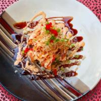 Dragon Extreme Roll · Tuna, salmon, avocado, eel and masago topped with cayenne pepper, hot sauce and eel sauce.