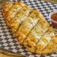 Cheesy Bread Sticks · Our house-made cheesy bread sticks baked in our brick-line ovens. Served with a side of mari...