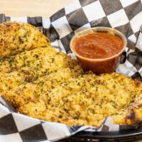 Garlic & Parmesan Bread Sticks · Garlic and Parmesan bread sticks baked in our own brick-lined ovens. Served with a side of m...