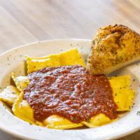 Ravioli · Three-cheese-filled ravioli topped with our house-made marinara. Served with a house baked p...