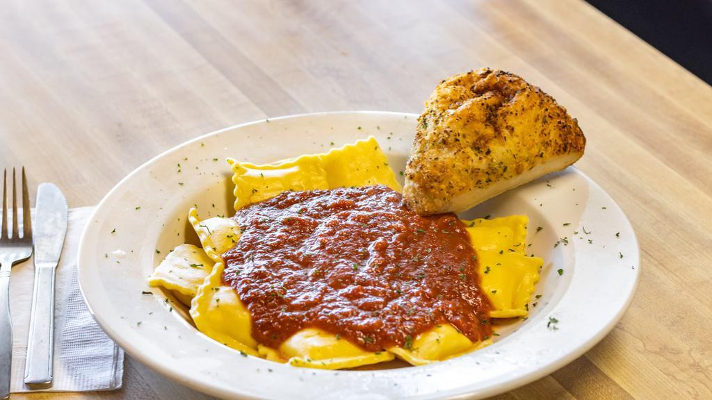 Ravioli · Three-cheese-filled ravioli topped with our house-made marinara. Served with a house baked pizza roll.