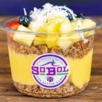 Mango-Pineapple Bowl · We blend mango, pineapple and banana with coconut milk to make a thick fruit smoothie. We th...